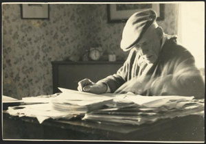 James Cowan at his desk, writing