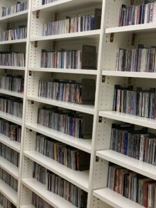 Large shelves from our storage facility, packed to the brim with CDs available for reserve