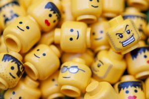 An assortment of Lego minifig heads with different facial expressions