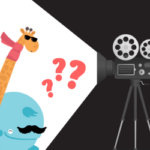 A giraffe wearing sunglasses and a whale with a false moustache stand in front of a beam of light cast by a camera