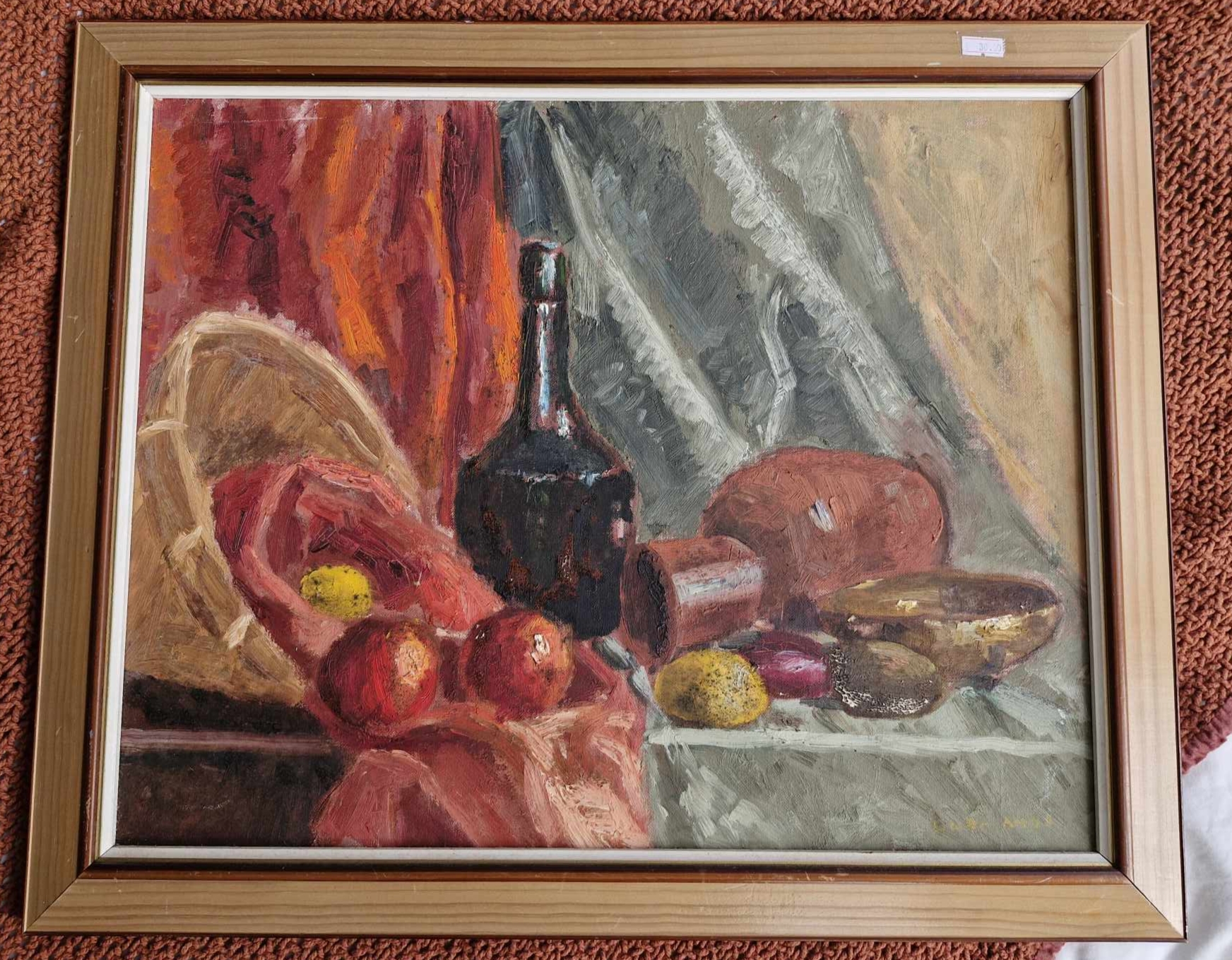 A photograph of a framed painting, depicting a still life of fruit and drinking vessels.