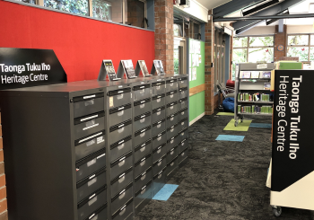 Filing cabinets andshelves of local history books, part of Taonga Tuku Iho Heritage Centre at Cummings Park Library