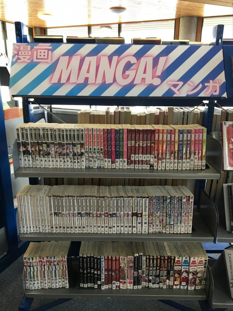 An arrangement of new manga series on the shelf at Newtown Library